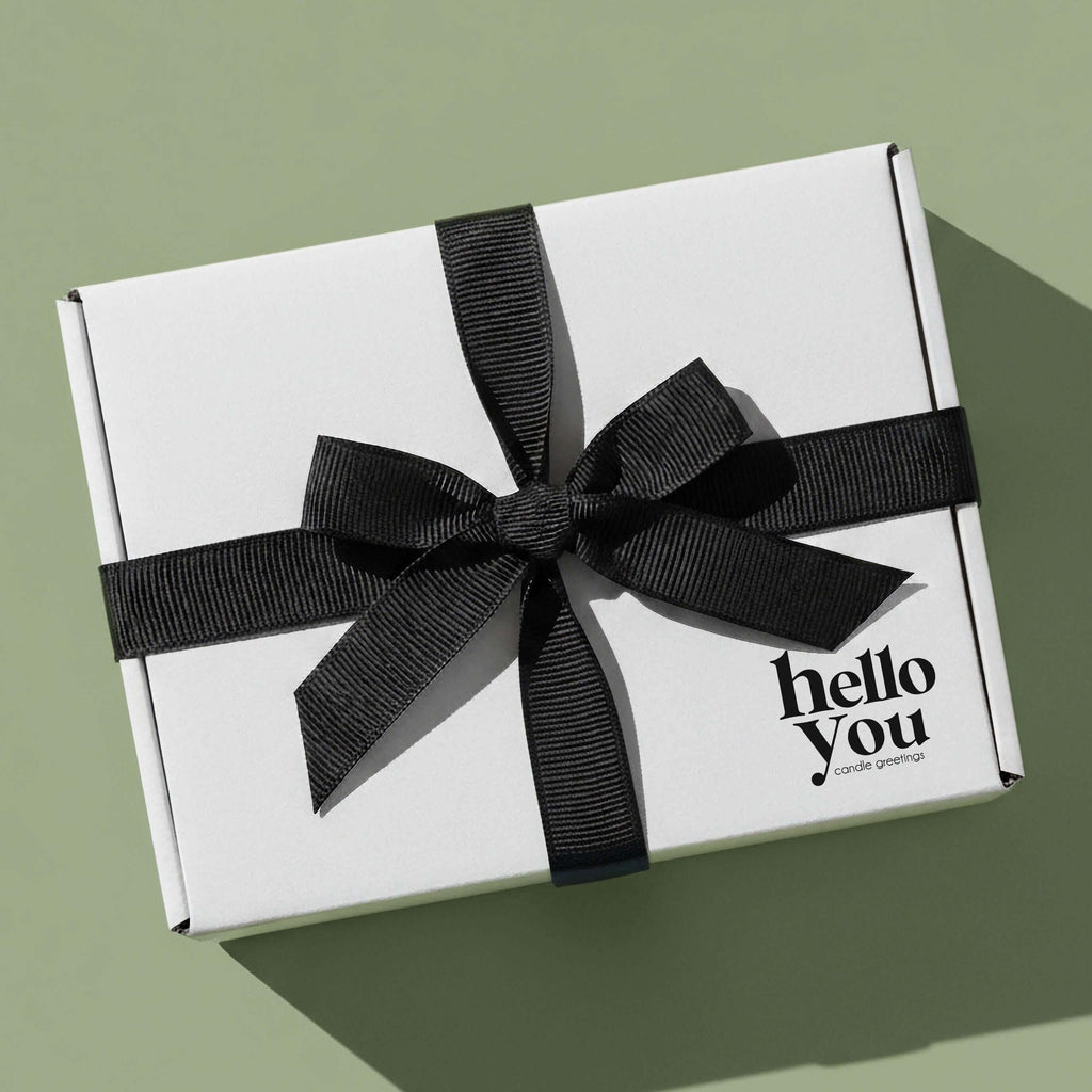Thank you gift candle presented in a beautifully wrapped white box with a black ribbon.